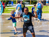 Boy playing in water spray at splash pad
