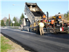 The final layer of asphalt is placed on River Road