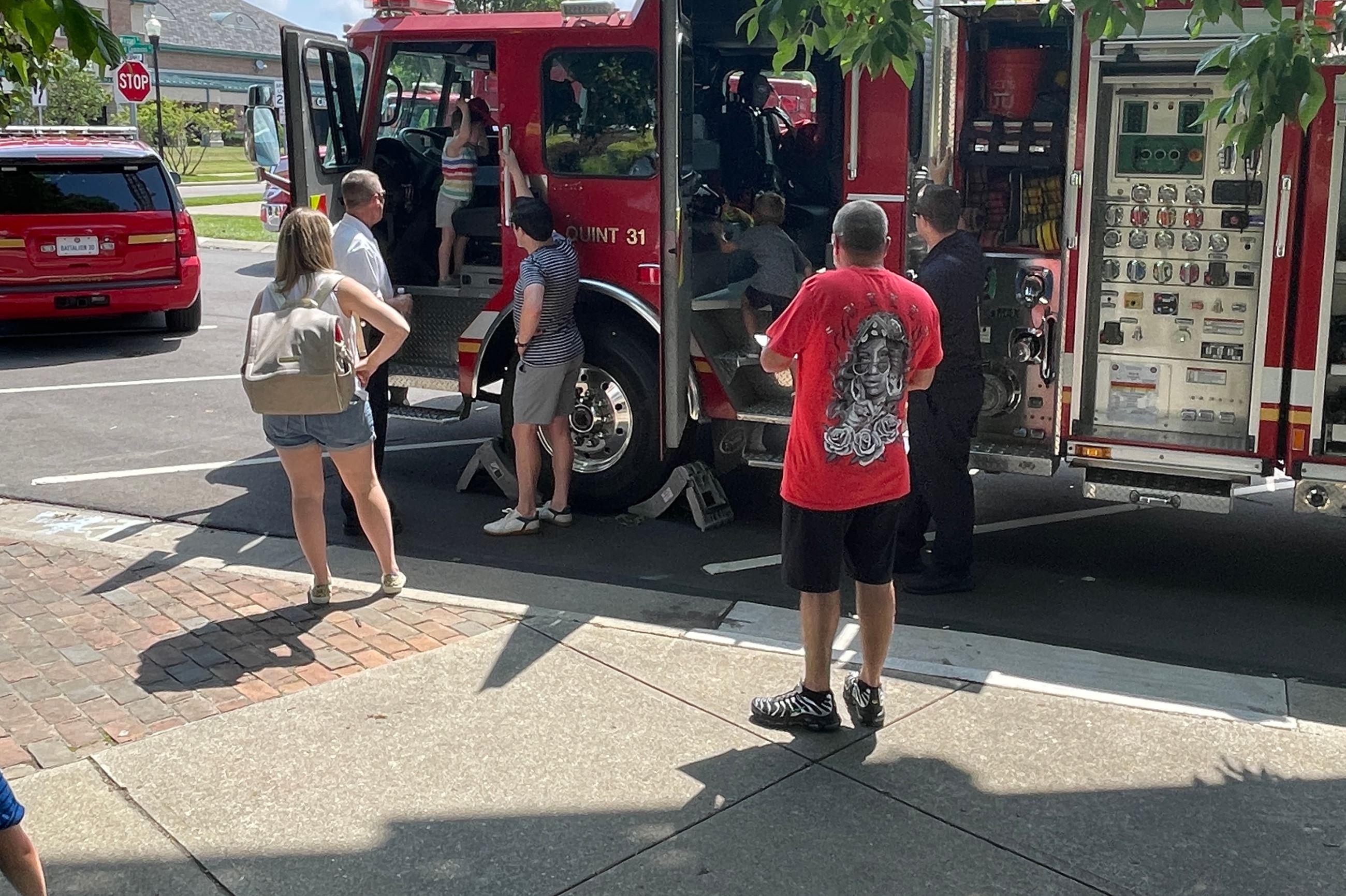 Kids and families climbing and enjoying the vehicles at Touch-A-Truck