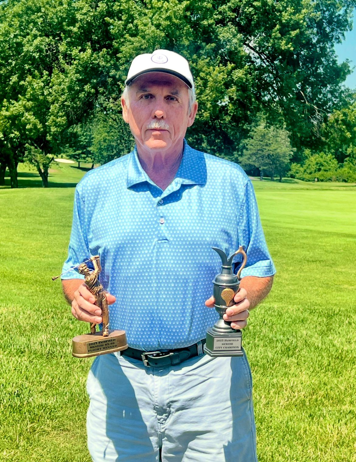 Gary Cobb, 2025 Fairfield Senior Men’s Champion, holding two trophies.