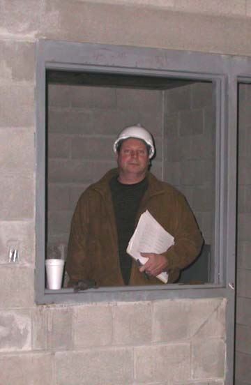 Man standing with paper work in construction zone
